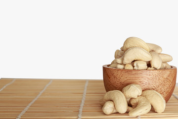 Cashew nut isolated on white background with floor wooden