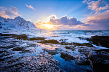 Obraz premium Coast of Norwegian sea on rocky coast in fjord on sunset