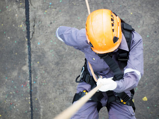 Firefighters are rappelling and climbing ropes at a drill exercise