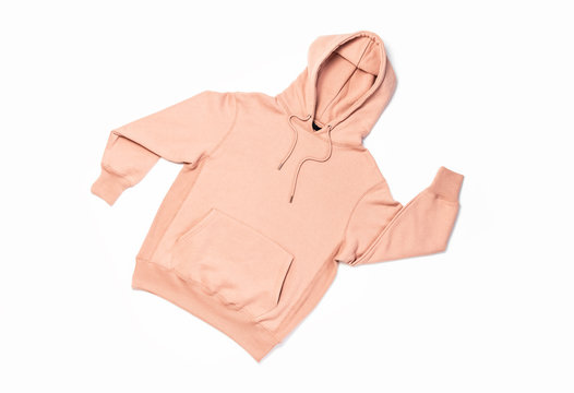 Female peach pink sweatshirt with pocket and hood isolated on white background. Fashionable women's clothing, hoody, casual youth style, sports. Autumn fashion