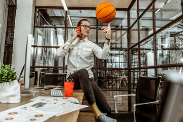 Relaxed office worker playing with ball during pause
