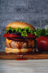 Hamburger or sandwich. Delicious sandwich hamburger with meat, cheese and fresh vegetable. Hamburger or sandwich is the popular fast food for brunch or lunch. Juicy cheeseburger