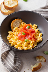 Omelette with smoked salmon, scrambled eggs, tasty healthy breakfast with toast and fish. Morning food, seafood, organic food