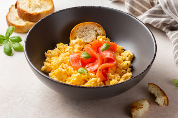 Omelette with smoked salmon, scrambled eggs, tasty healthy breakfast with toast and fish. Morning food, seafood, organic food