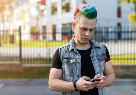 Young punk man with smart phone
