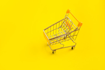 Shopping cart on yellow background