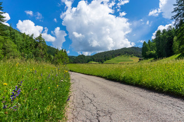 Road with a beautiful view. Santa Maddalena village, Dolomites, Val di Funes, Italy.