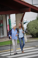 Homehelp woman shopping with elderly lady