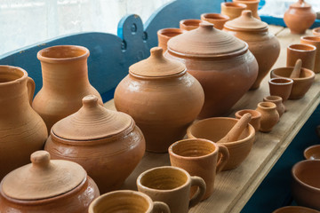Brown clay pots made in ground oven with firewoods using old traditional ukrainian pottery technology.