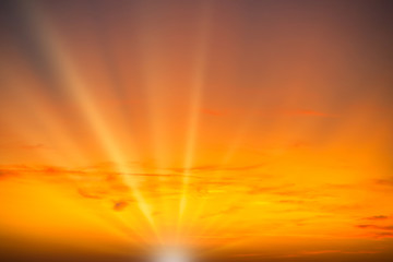 Sunset sky with red clouds and sun rays