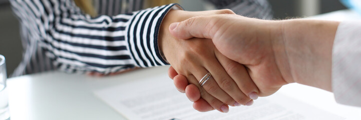 Man and woman shaking hands after productive deliberations closeup - obrazy, fototapety, plakaty