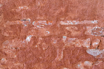 Texture of old red clay plaster on the wall