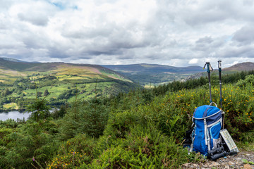 Backpack, binoculars, map and sticks on the mountain, mountain lifestyle in Ireland.