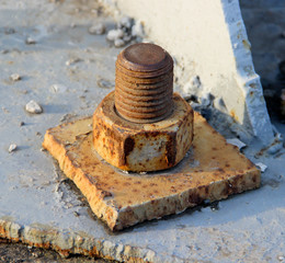 Old Rusty Bolt and Nut in a Metal Plate