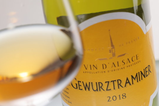 Bottle and glass with Gewurztraminer, sweet white wine  from  the Alsace region of France, September 30, 2019 Saint-Petersburg, Russia