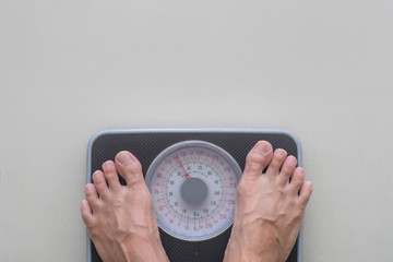 Feet standing on weight Scale.Concept of diet
