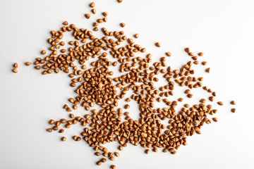 Close up of buckwheat grains isolated on white background. Top view