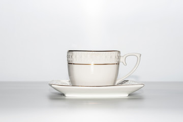 White cup and saucer on a white background