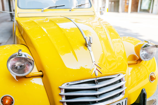 26 JULY 2018, VIC, SPAIN: Yellow Citroen retro car on city street