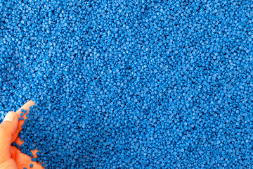 Close-up of plastic polymer granules. hand hold Polymer pellets. polymer plastic. compound polymer.