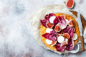Cauliflower pizza crust with figs, radicchio and .goat's cheese. Vegetarian, grain free, low carb, gluten free diet concept