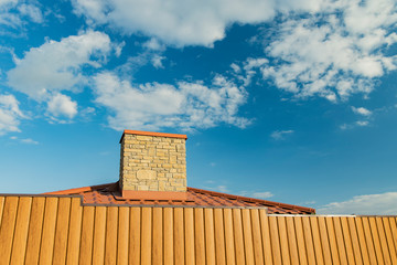 Fototapeta premium chimney outskirt home building landmark pollution landscaping object, vivid blue sky white clouds poster background empty copy space for text