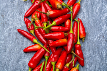 Fresh small red hot chili peppers on grey background © barmalini