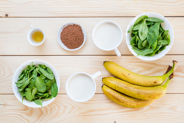 Ingredients for Smoothie (Spinach Leaves, Almond Milk, Almond Oil, Cacao Powder, Banana)