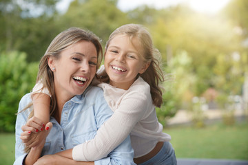 Naklejka premium Portrait of cheerful mother and daughter