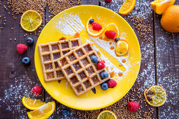 Homemade Waffles with Buckwheat Meal, Berries, Orange and Powdered Sugar