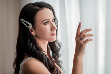 Fototapeta premium close up. smiling bride looking through the window