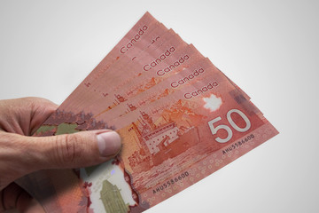 Hand holding Canadian dollars. CAD. Currency of Canada