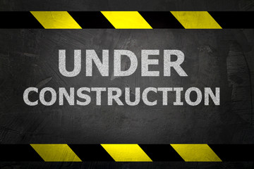 under construction sign on black background