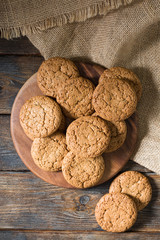 Oatmeal cookies on a wooden round Board. Rustic style. Top view