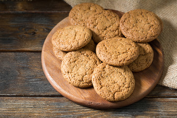 Oatmeal cookies on a wooden round Board. Rustic style. Top view