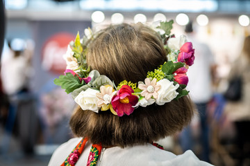 Polish woman in traditional polish folk dress wearing a flower crown.