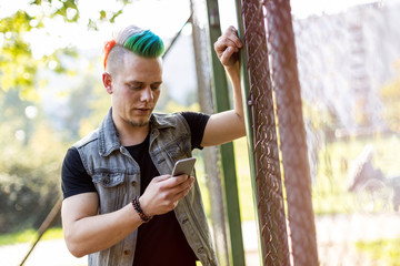 Young punk man with smart phone