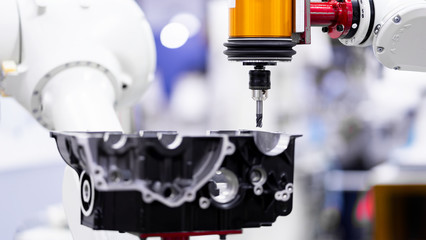 High precision CNC machining center independent axis movement  working, engineer control hand robot machining automotive sample part process in the factory