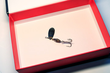 fishing lure with hook for fishing in a box