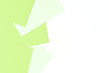 Light background with isolated white and green sheets of paper.