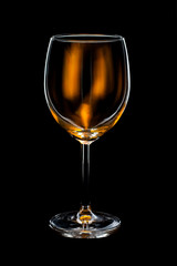 empty wine glass with orange light on black background