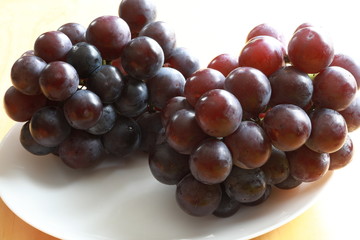Black grapes on white background