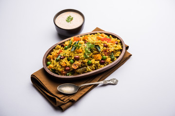 Broken wheat or Daliya Upma, served in a bowl. selective focus