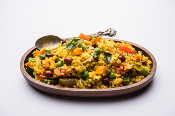 Broken wheat or Daliya Upma, served in a bowl. selective focus