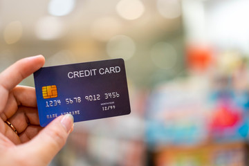 Using a credit card to make online purchases Enjoy shopping from your computer, Hand holding credit card, Finance concept.