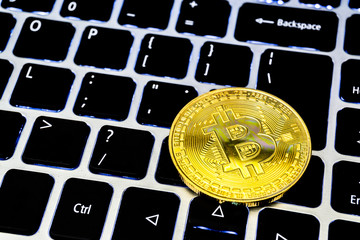 Bitcoin on keyboard and money concept. golden coin with icon letter B.Mining, Business concept.
