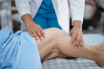 Physiotherapist doing physical therapy in rehab with patient in nursing hospital ward : healthy...