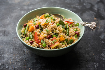 Broken wheat or Daliya Upma, served in a bowl. selective focus