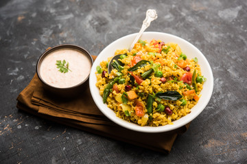 Broken wheat or Daliya Upma, served in a bowl. selective focus