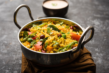 Broken wheat or Daliya Upma, served in a bowl. selective focus
